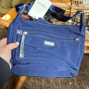 “Out and about bagg” with wristlet. New with bags, rich blue color.